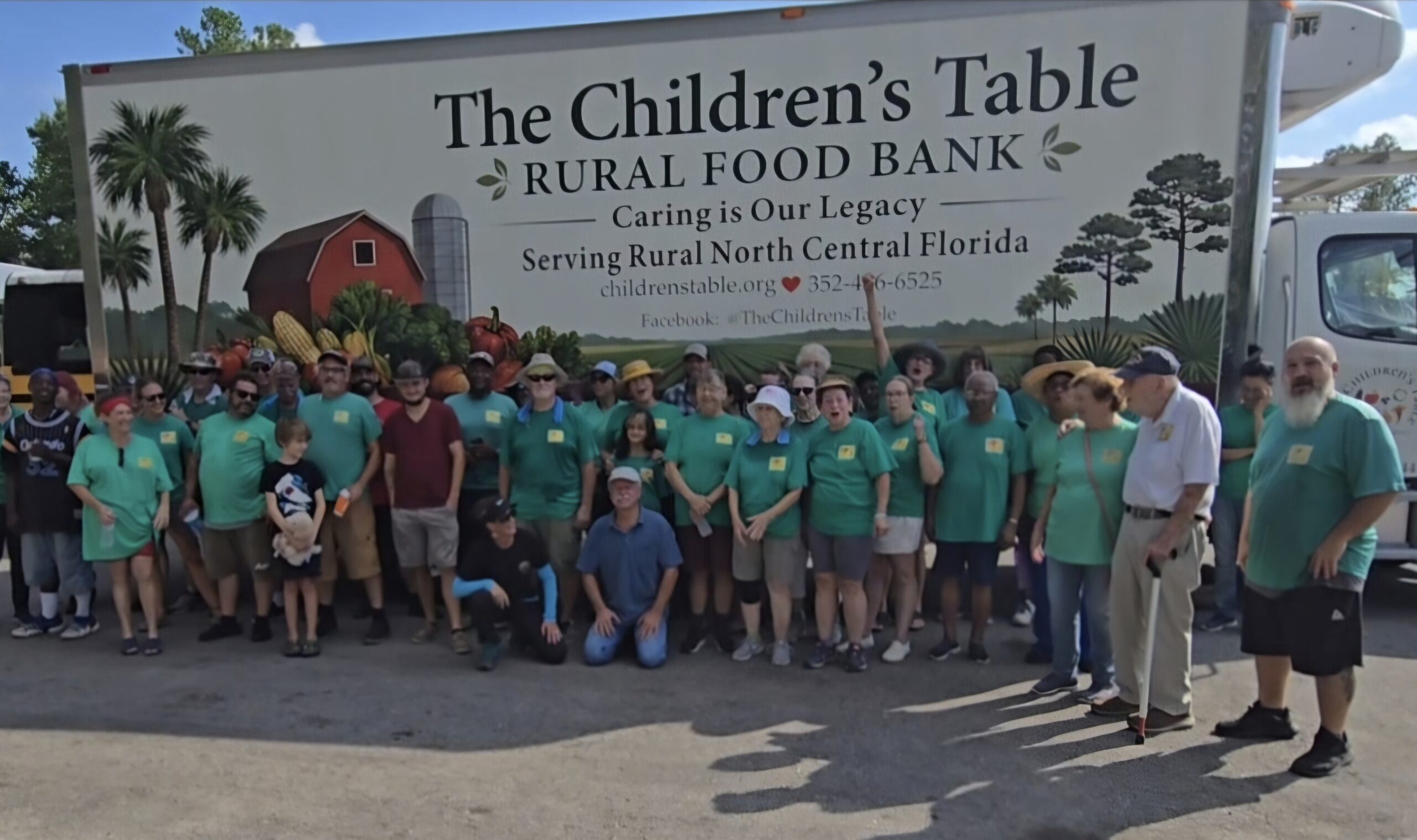 The Children's Table volunteer team gathered in front of the food bank truck